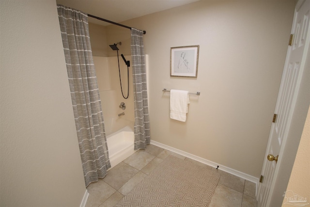 bathroom featuring tile patterned floors, shower / bathtub combination with curtain, and baseboards