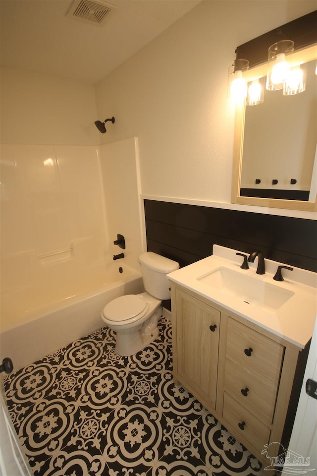 full bath featuring visible vents, toilet,  shower combination, vanity, and tile patterned floors