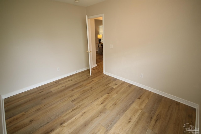 unfurnished room featuring light wood-style floors and baseboards