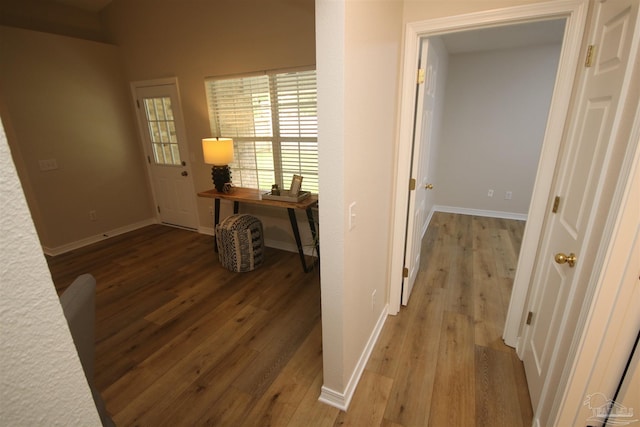 corridor with wood finished floors and baseboards