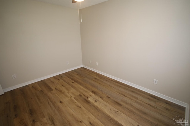 unfurnished room with wood finished floors, ceiling fan, and baseboards