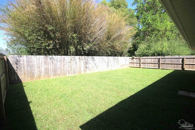 view of yard with a fenced backyard