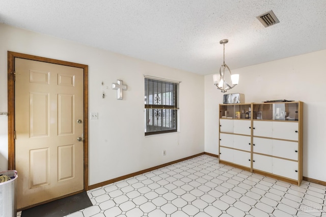 921 Candlestick Dr, Pensacola, FL 32514 - foyer featuring light flooring, a textured ceiling, and baseboards