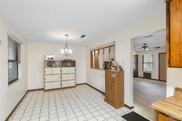 921 Candlestick Dr, Pensacola, FL 32514 - dining room with baseboards, light floors, a ceiling fan, a chandelier, and a textured ceiling