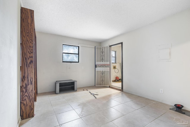 921 Candlestick Dr, Pensacola, FL 32514 - empty room with a textured ceiling and light tile patterned floors