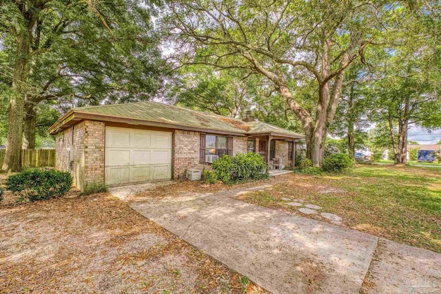 921 Candlestick Dr, Pensacola, FL 32514 - ranch-style home featuring driveway, a garage, brick siding, and cooling unit
