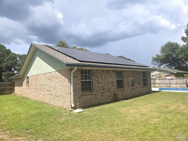 5358 Jenny Cir, Pace, FL 32571 - view of property exterior with solar panels and brick siding