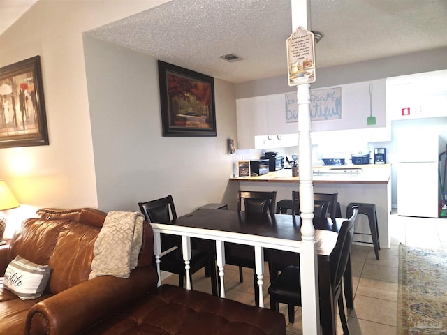 5358 Jenny Cir, Pace, FL 32571 - dining space featuring light tile patterned floors and a textured ceiling