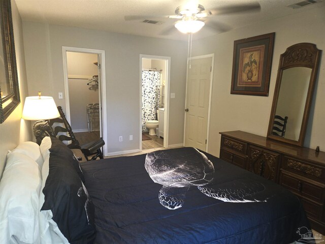 5358 Jenny Cir, Pace, FL 32571 - bedroom with a walk in closet, ensuite bathroom, wood finished floors, and a ceiling fan