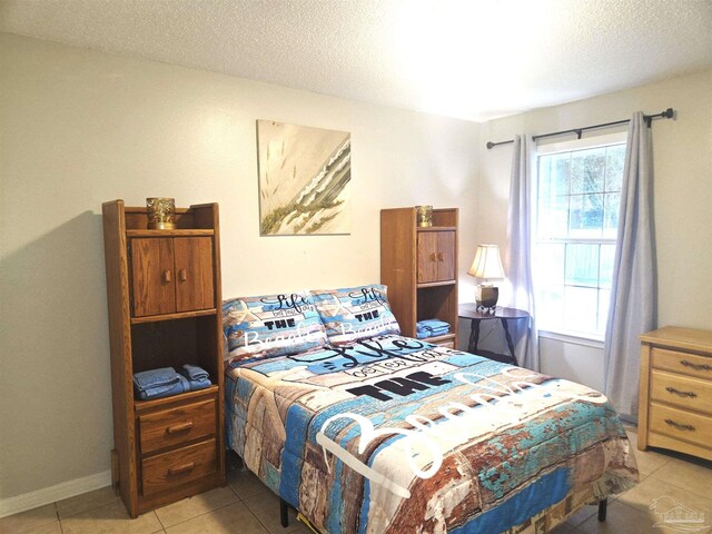 5358 Jenny Cir, Pace, FL 32571 - bedroom featuring light tile patterned flooring and a textured ceiling