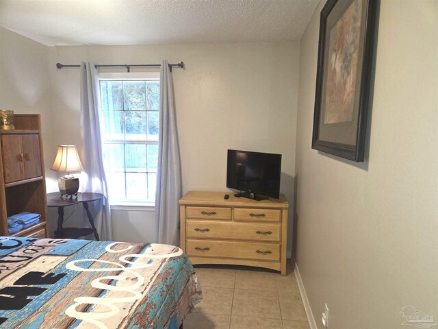 5358 Jenny Cir, Pace, FL 32571 - bedroom with light tile patterned floors and a textured ceiling