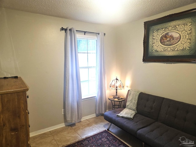 5358 Jenny Cir, Pace, FL 32571 - living room featuring plenty of natural light, a textured ceiling, and light tile patterned flooring