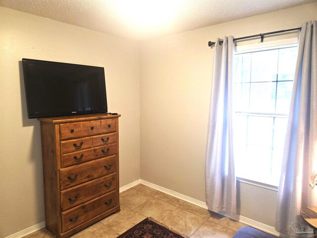 5358 Jenny Cir, Pace, FL 32571 - bedroom featuring a textured ceiling and light tile patterned floors