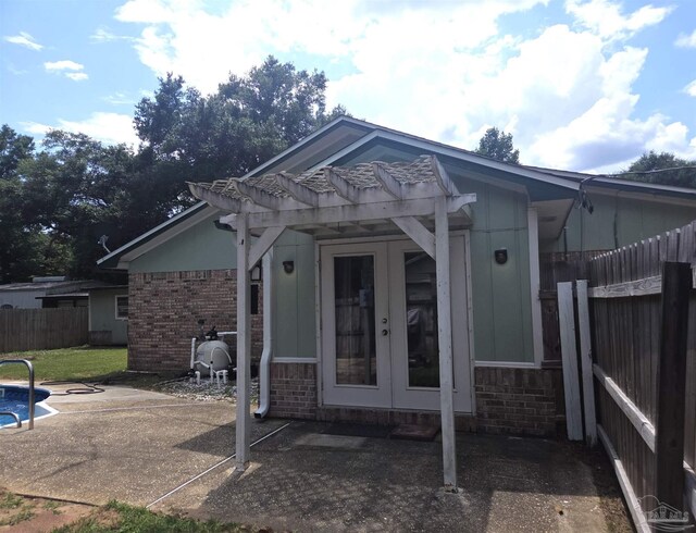 5358 Jenny Cir, Pace, FL 32571 - entrance to property with french doors, brick siding, a pergola, and a patio