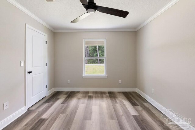 9317 Alekai Dr, Pensacola, FL 32526 - empty room featuring ceiling fan, a textured ceiling, wood finished floors, and crown molding
