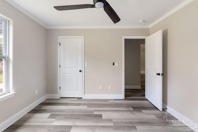 9317 Alekai Dr, Pensacola, FL 32526 - unfurnished bedroom with light wood-style flooring, a textured ceiling, crown molding, and ceiling fan