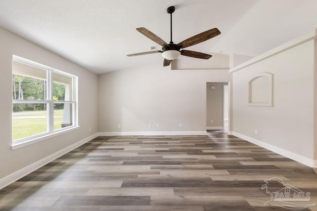 9317 Alekai Dr, Pensacola, FL 32526 - empty room featuring vaulted ceiling, a ceiling fan, wood finished floors, and a textured ceiling