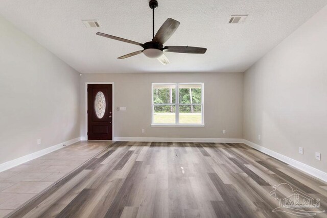 9317 Alekai Dr, Pensacola, FL 32526 - foyer entrance with ceiling fan, a textured ceiling, and wood finished floors