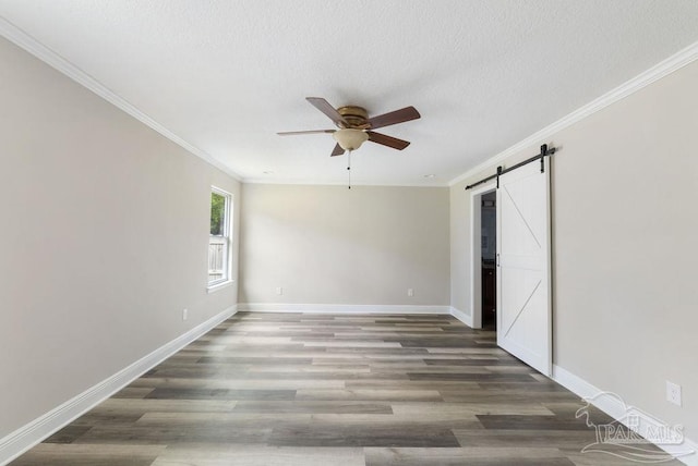 9317 Alekai Dr, Pensacola, FL 32526 - unfurnished room with a ceiling fan, a barn door, ornamental molding, wood finished floors, and a textured ceiling