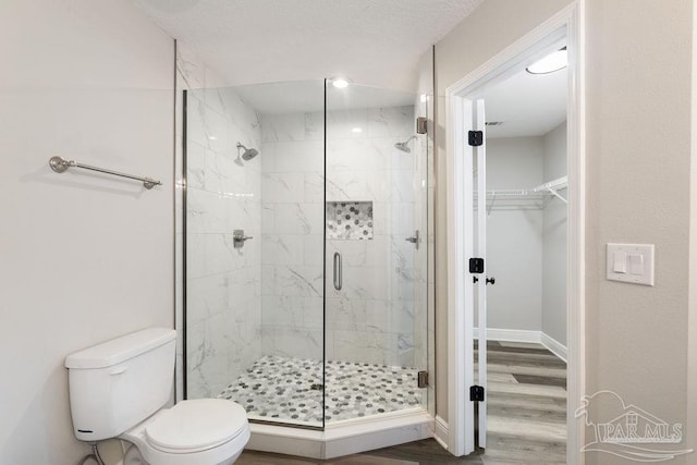 9317 Alekai Dr, Pensacola, FL 32526 - bathroom featuring a shower stall, a spacious closet, and wood finished floors