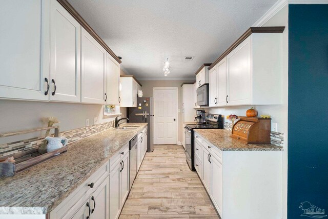 8150 Northpointe Blvd, Pensacola, FL 32514 - kitchen with appliances with stainless steel finishes, a sink, ornamental molding, light wood-style flooring, and decorative backsplash