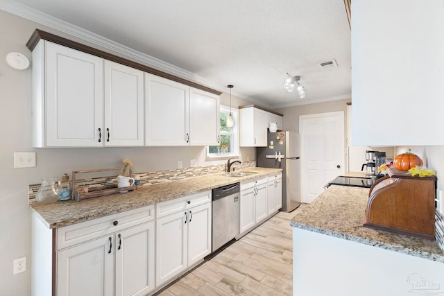 8150 Northpointe Blvd, Pensacola, FL 32514 - kitchen with stainless steel appliances, a sink, crown molding, white cabinetry, and light wood-style floors
