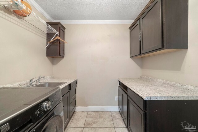 8150 Northpointe Blvd, Pensacola, FL 32514 - clothes washing area with washer / dryer, cabinet space, crown molding, baseboards, and a textured ceiling