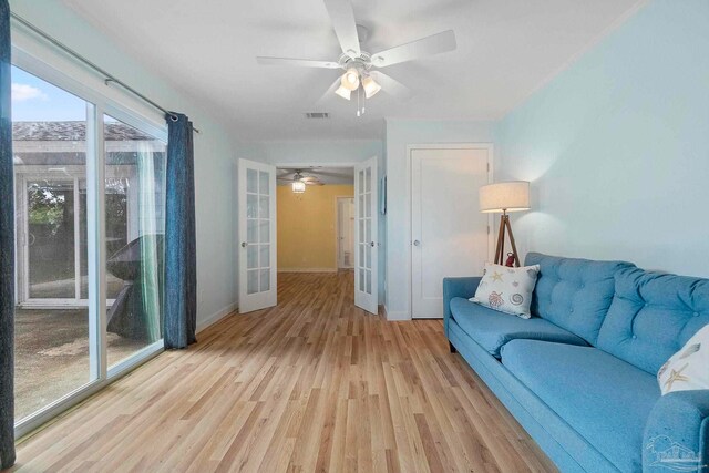 8150 Northpointe Blvd, Pensacola, FL 32514 - living area with french doors, ceiling fan, light wood-style floors, and baseboards