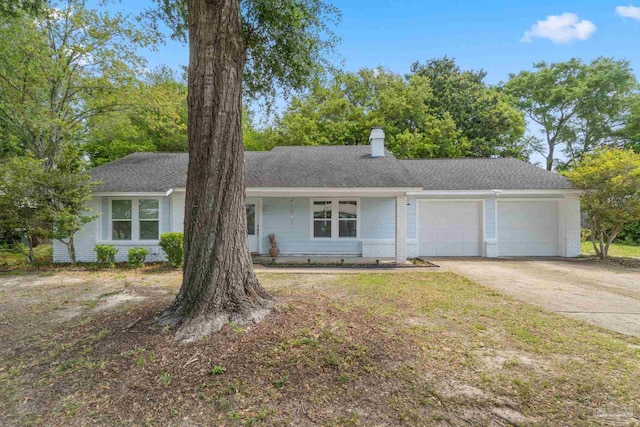 8150 Northpointe Blvd, Pensacola, FL 32514 - view of front of property featuring an attached garage, driveway, a chimney, and brick siding