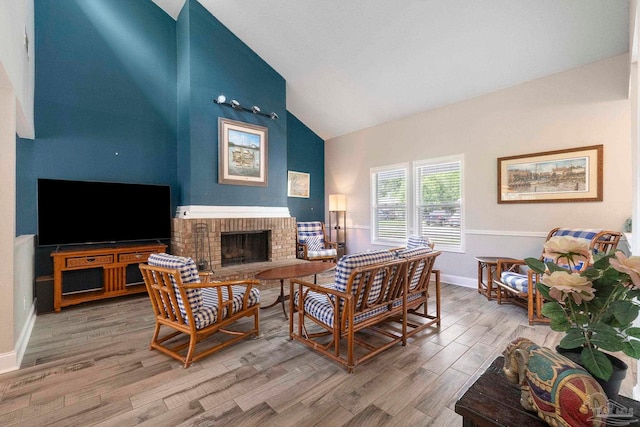 8150 Northpointe Blvd, Pensacola, FL 32514 - living room with high vaulted ceiling, a brick fireplace, wood finished floors, and baseboards