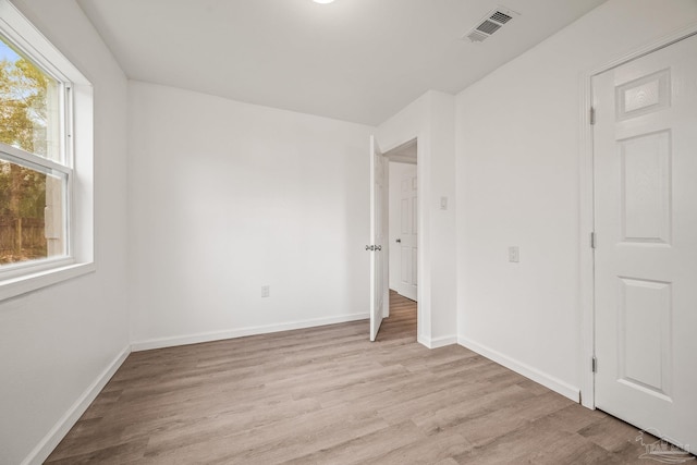 unfurnished bedroom featuring visible vents, baseboards, and light wood-style flooring