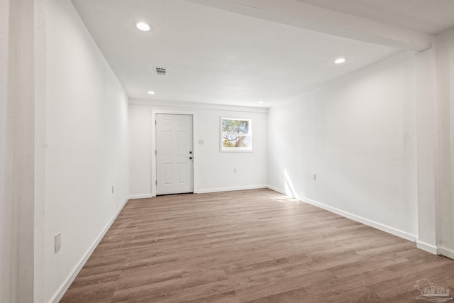 spare room with visible vents, recessed lighting, baseboards, and wood finished floors