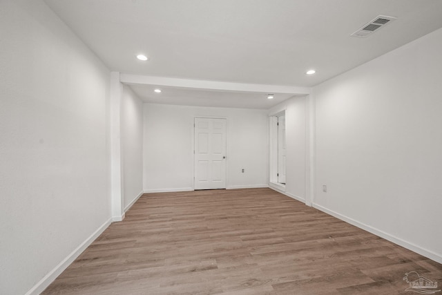 unfurnished room featuring recessed lighting, visible vents, light wood-style flooring, and baseboards