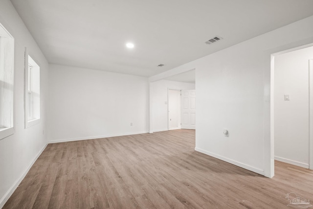 unfurnished room with visible vents, baseboards, and light wood finished floors