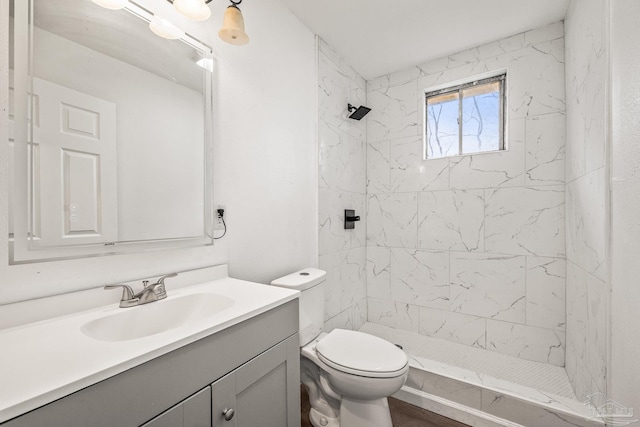 bathroom with vanity, toilet, and a stall shower