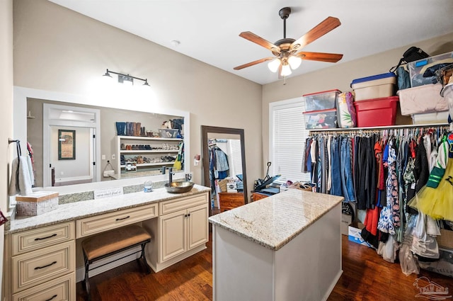 spacious closet featuring ceiling fan and dark hardwood / wood-style floors