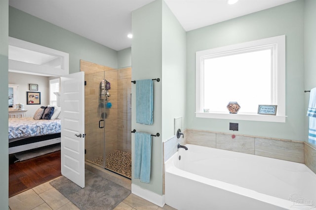 bathroom with tile patterned flooring and separate shower and tub