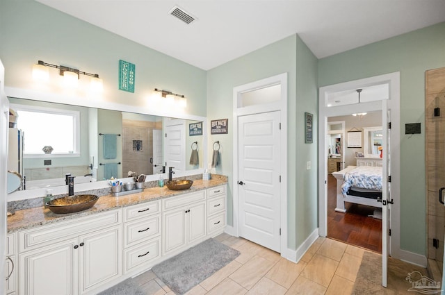 bathroom with vanity, walk in shower, and tile patterned floors