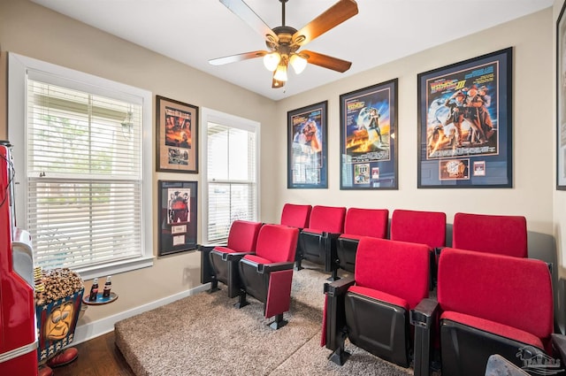 home theater with ceiling fan, a healthy amount of sunlight, and hardwood / wood-style floors