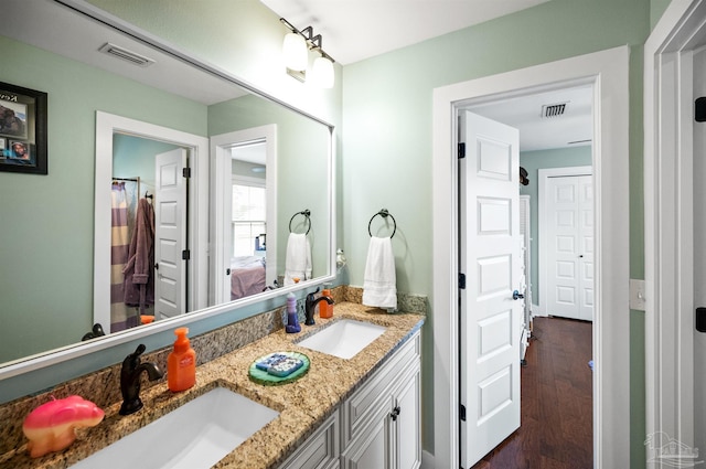 bathroom featuring vanity and hardwood / wood-style flooring