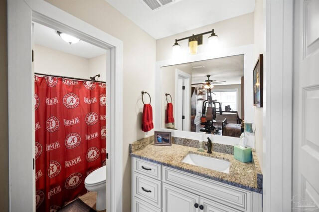 bathroom with toilet, ceiling fan, and vanity