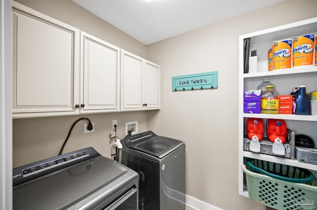 washroom featuring separate washer and dryer and cabinets