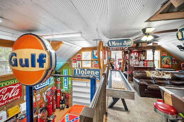 game room featuring ceiling fan, vaulted ceiling, carpet flooring, and bar