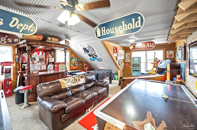 playroom featuring wooden walls, carpet flooring, and ceiling fan