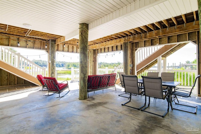 view of patio with outdoor dining space and stairs
