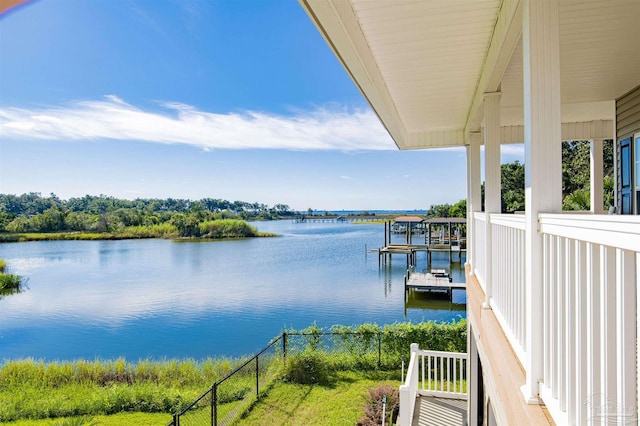 exterior space featuring a water view and fence