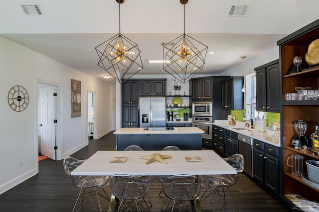 kitchen with visible vents, a sink, light countertops, and stainless steel appliances