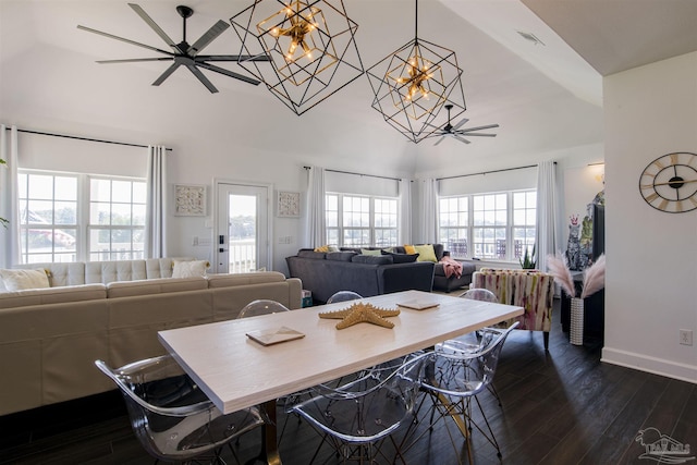 dining area featuring visible vents, vaulted ceiling, baseboards, ceiling fan with notable chandelier, and dark wood-type flooring