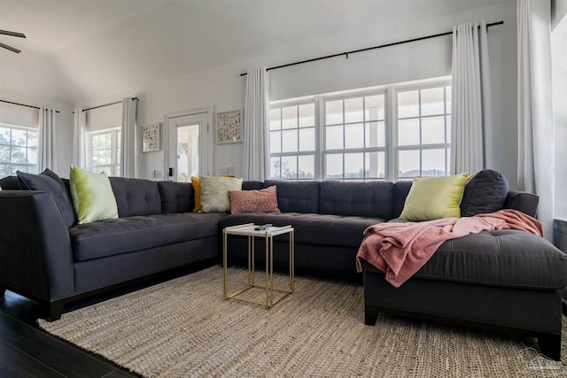 living area featuring vaulted ceiling and wood finished floors