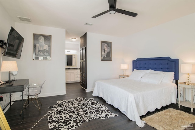 bedroom with baseboards, dark wood finished floors, and visible vents